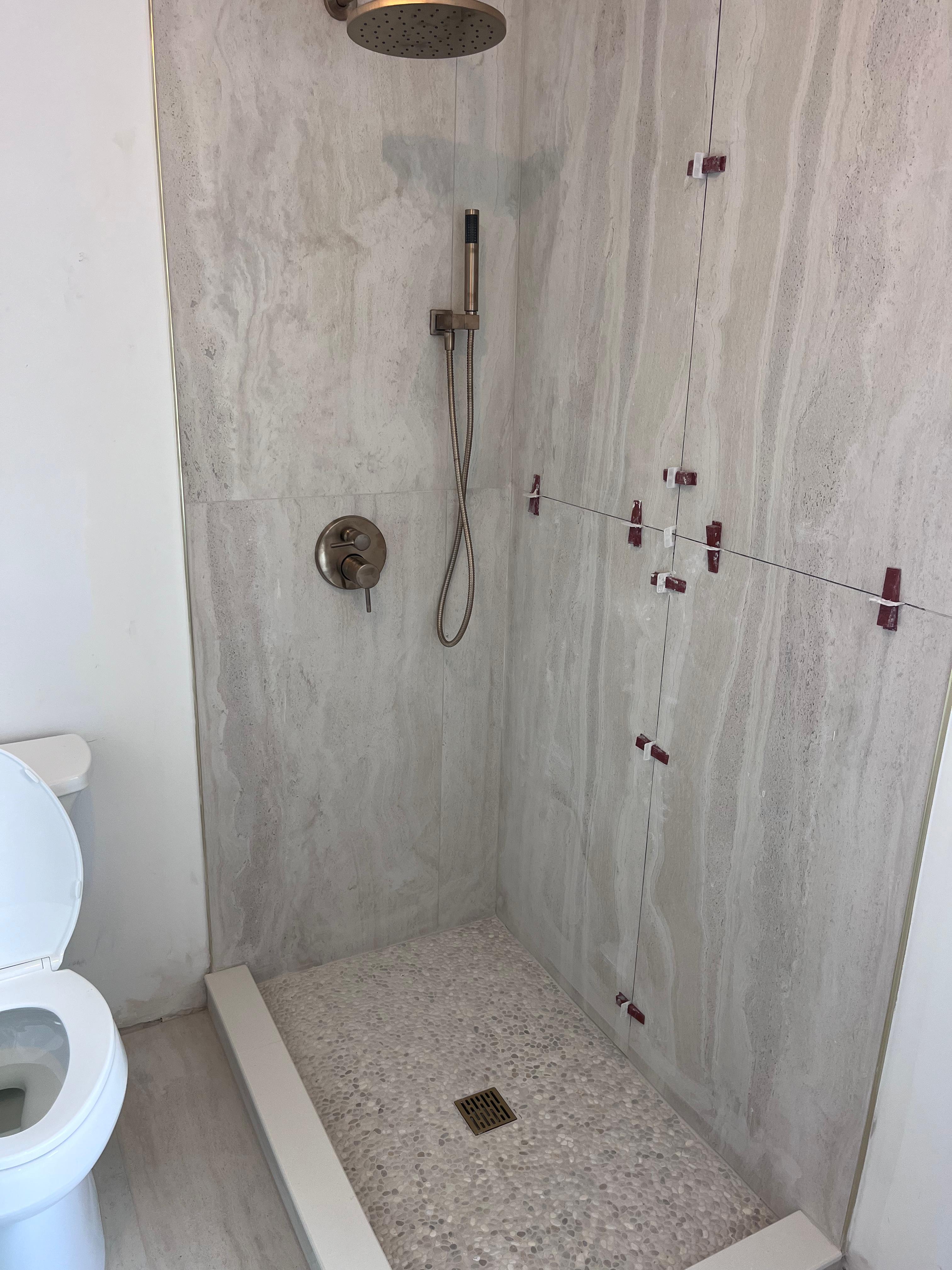 Before: shower during tile installation, no glass