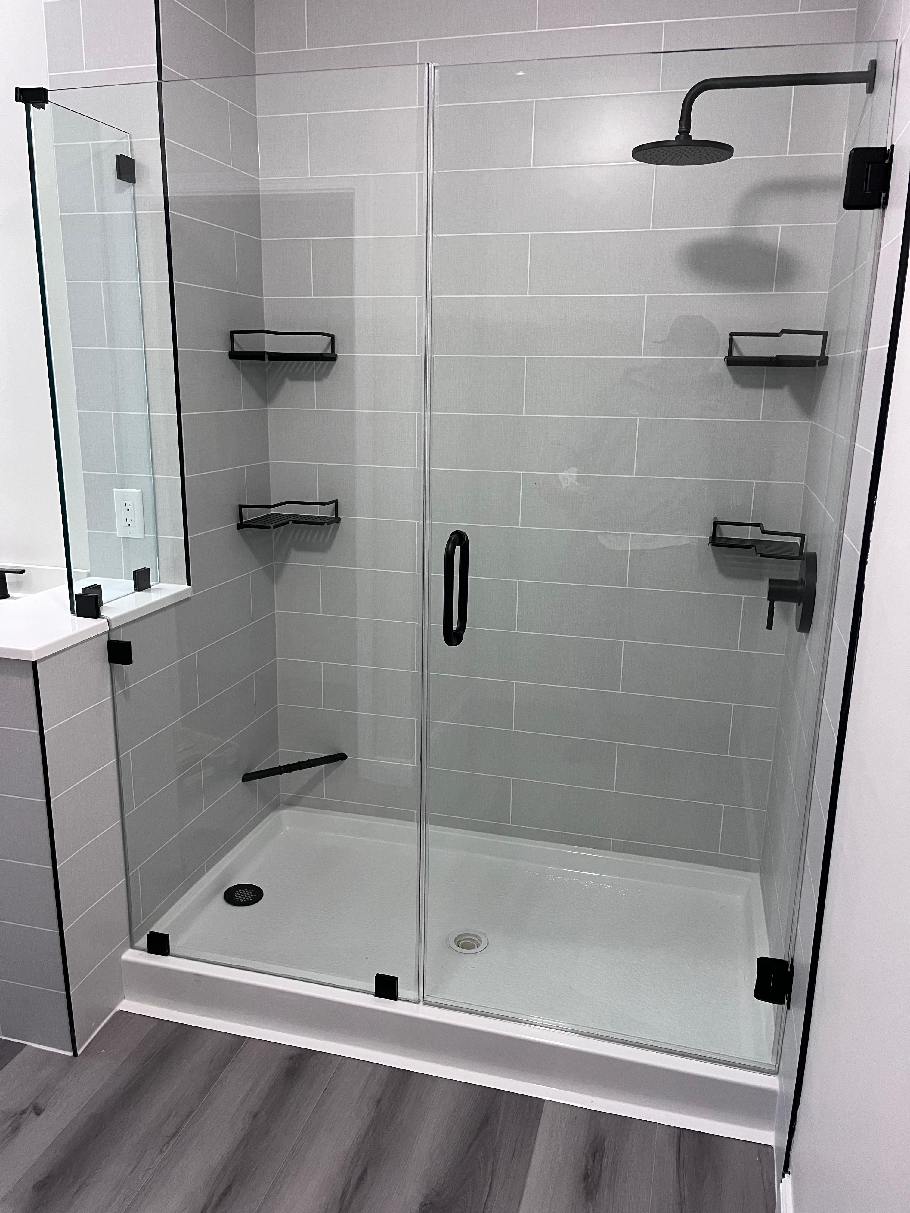 Before: shower pan and tile, no glass installed